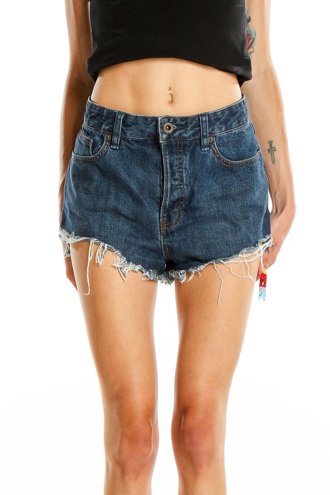 Front view of Free People blue denim distressed high-waisted shorts on model