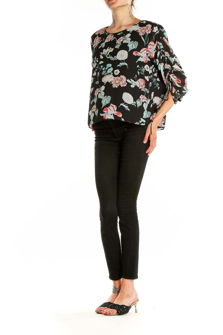 Front view of Vince Camuto black floral print top with ruched sleeves