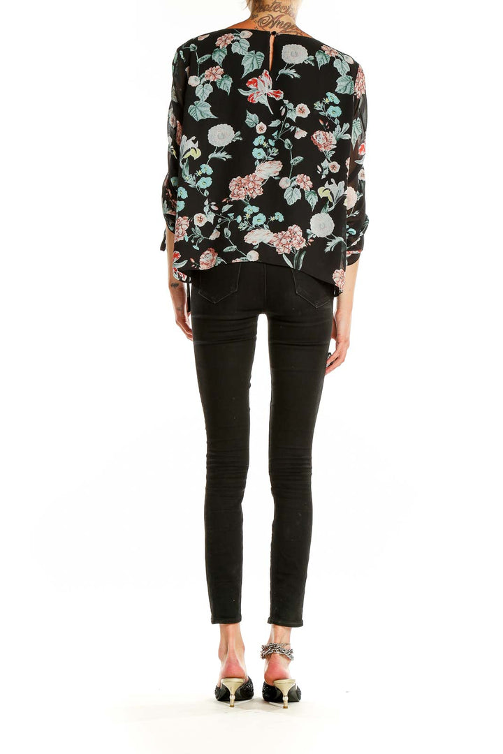 Back view of Vince Camuto black floral print top showing full pattern