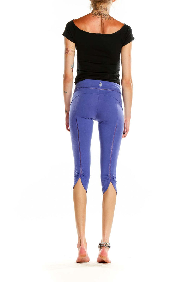 Back view of purple capri leggings showing ruched hem detail