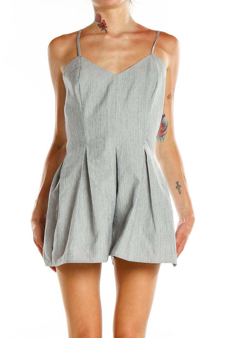 Front view of gray pleated romper with sweetheart neckline