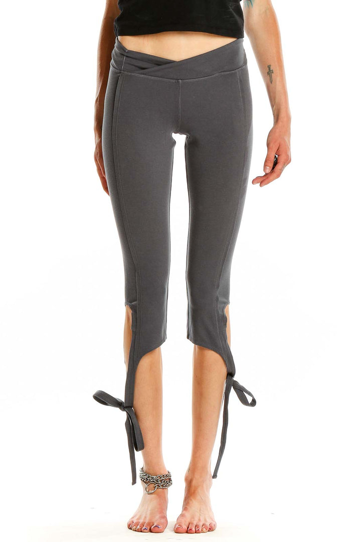 Front view of gray capri leggings with tie-ankle detail and cross-over waistband