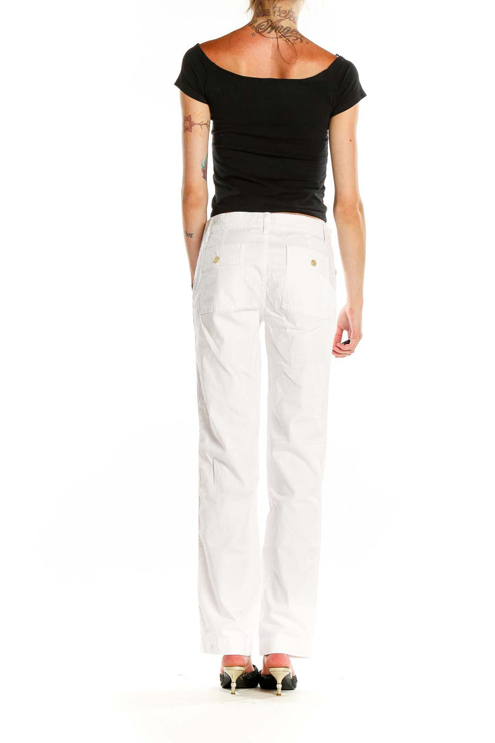 Back view of Tory Burch white classic straight-leg pants on model