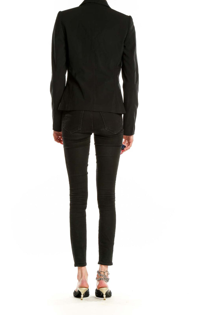 Back view of Elie Tahari black single-button blazer on model with skinny jeans