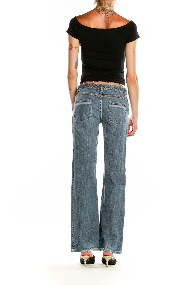 Back view of Michael Kors light blue wide-leg denim jeans on model