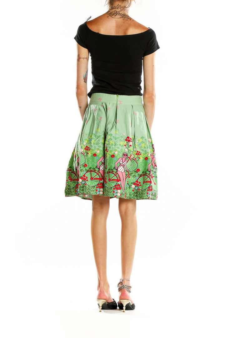 Back view of green pleated skirt with bicycle and floral print