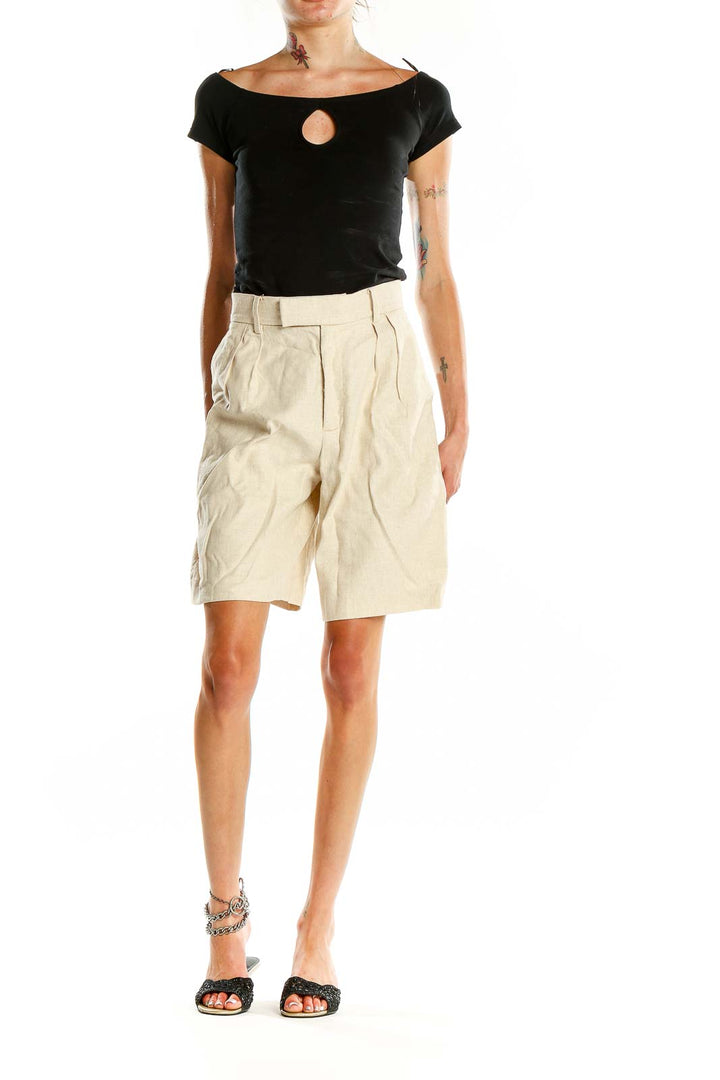 Front view of Banana Republic beige pleated Bermuda shorts on model