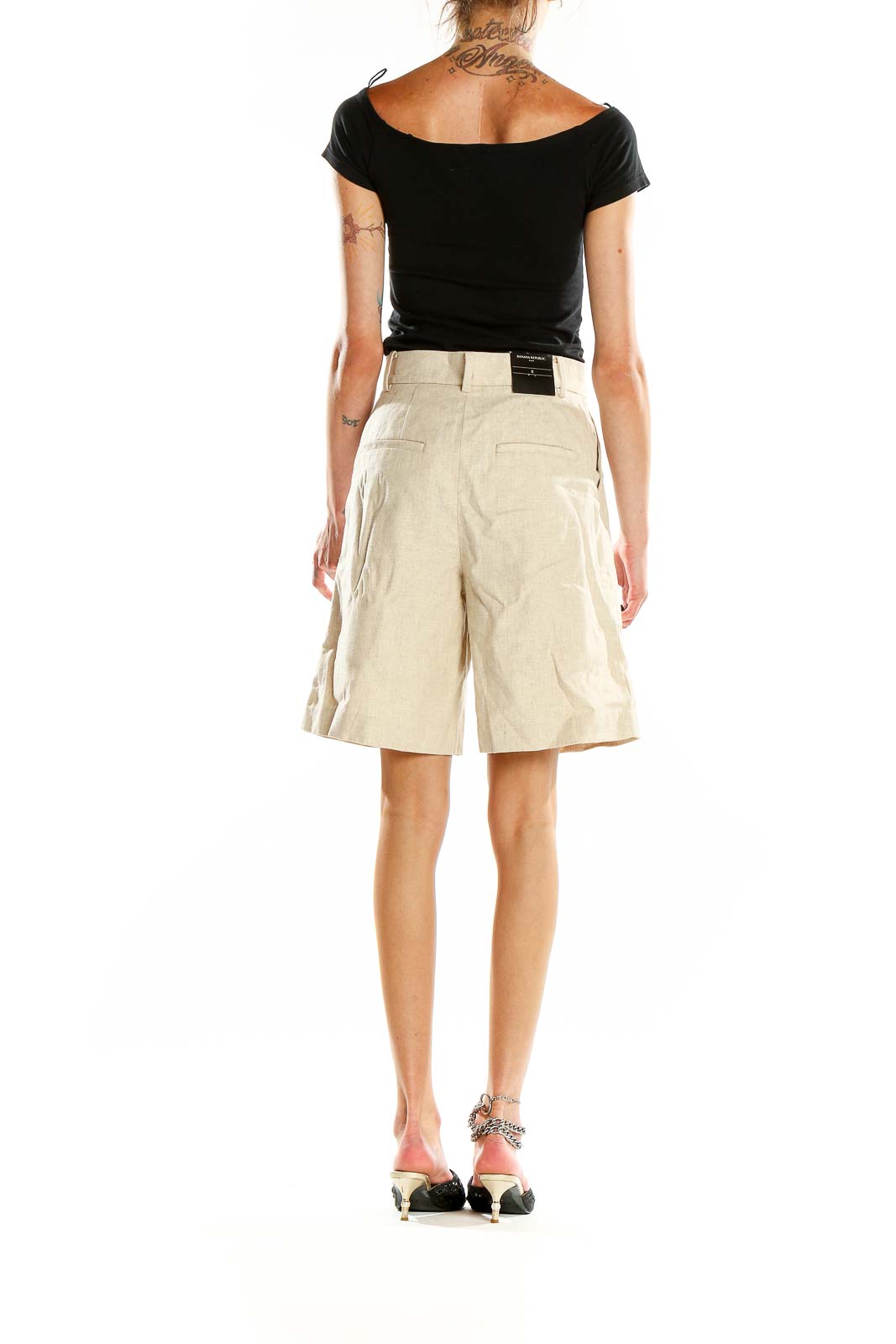 Back view of Banana Republic beige pleated Bermuda shorts on model