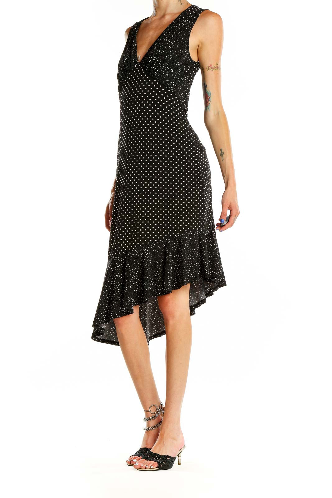 Front view of Leota black polka dot dress with V-neck and asymmetric hem