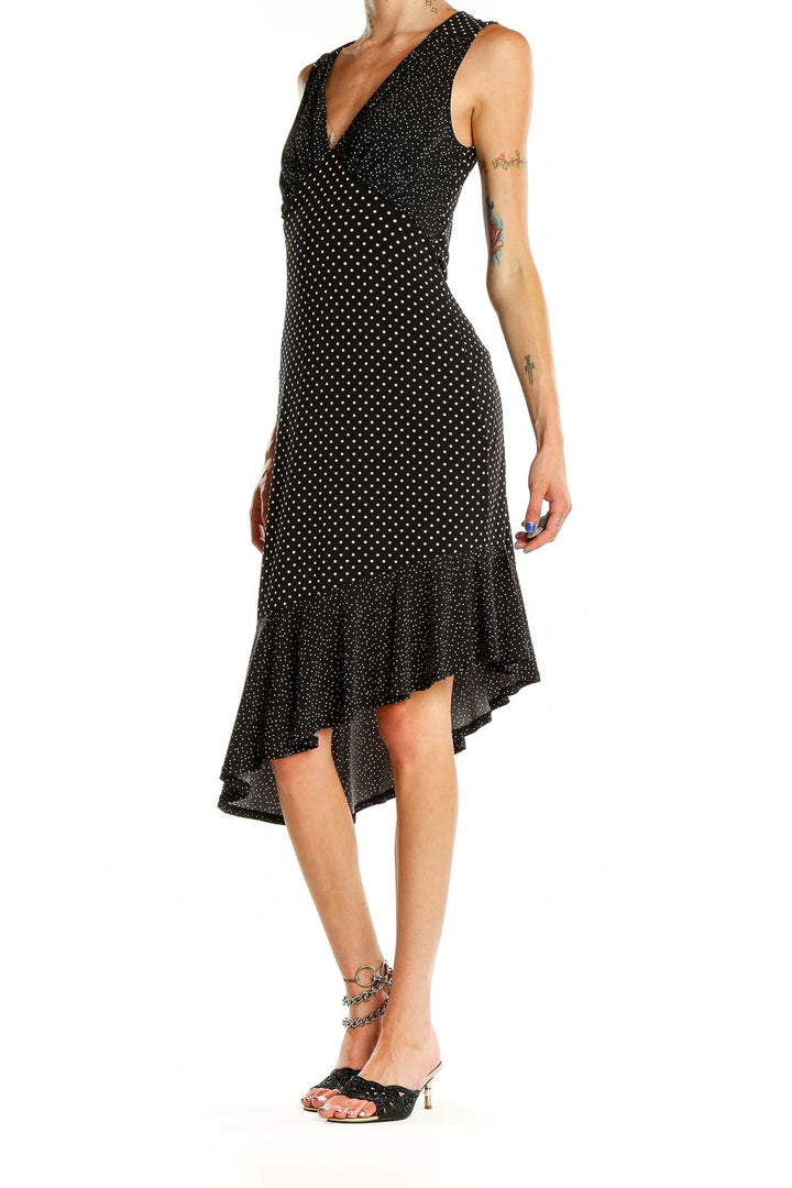 Front view of Leota black polka dot dress with V-neck and asymmetric hem