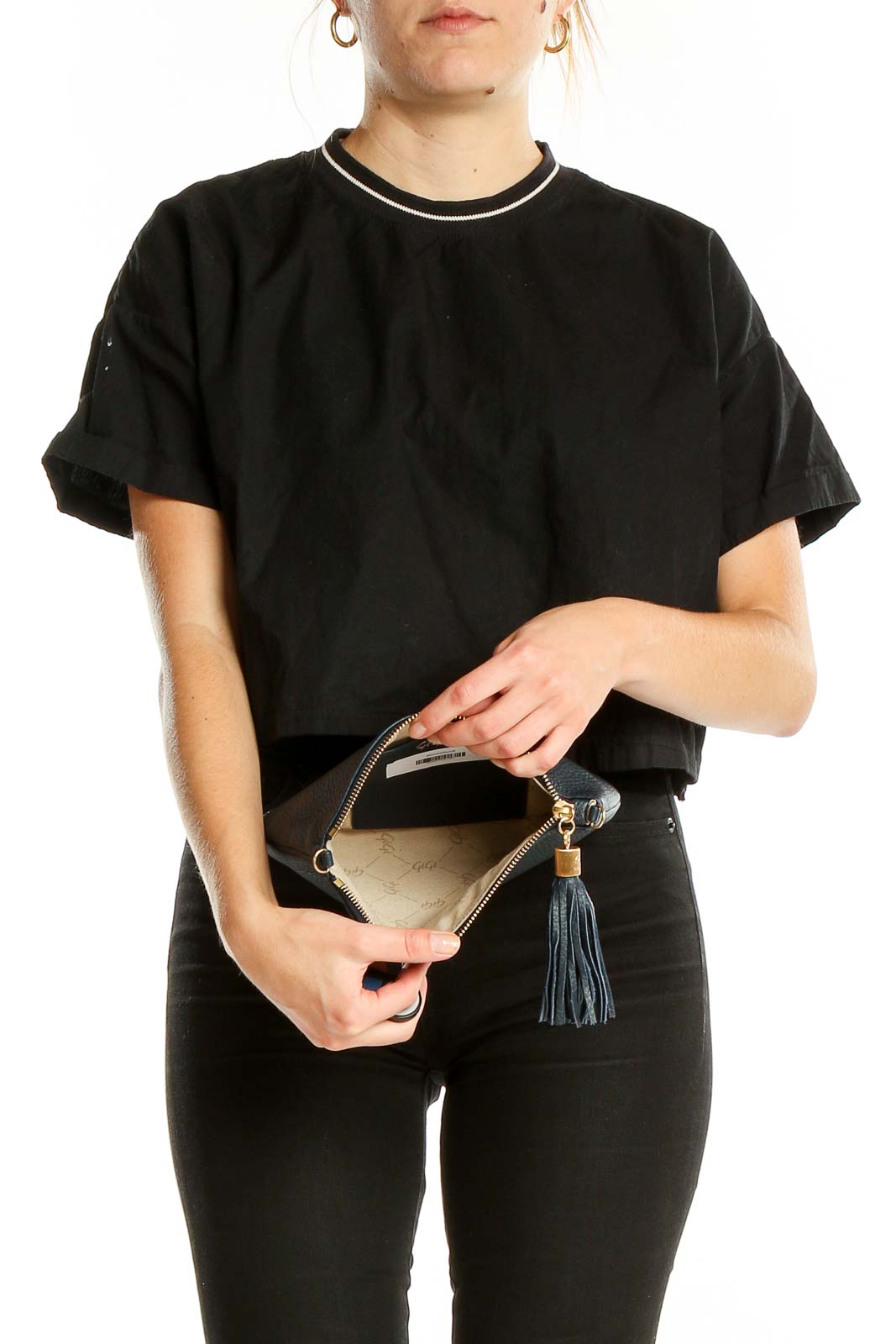 Woman holding GiGi New York black leather clutch, showcasing size and style