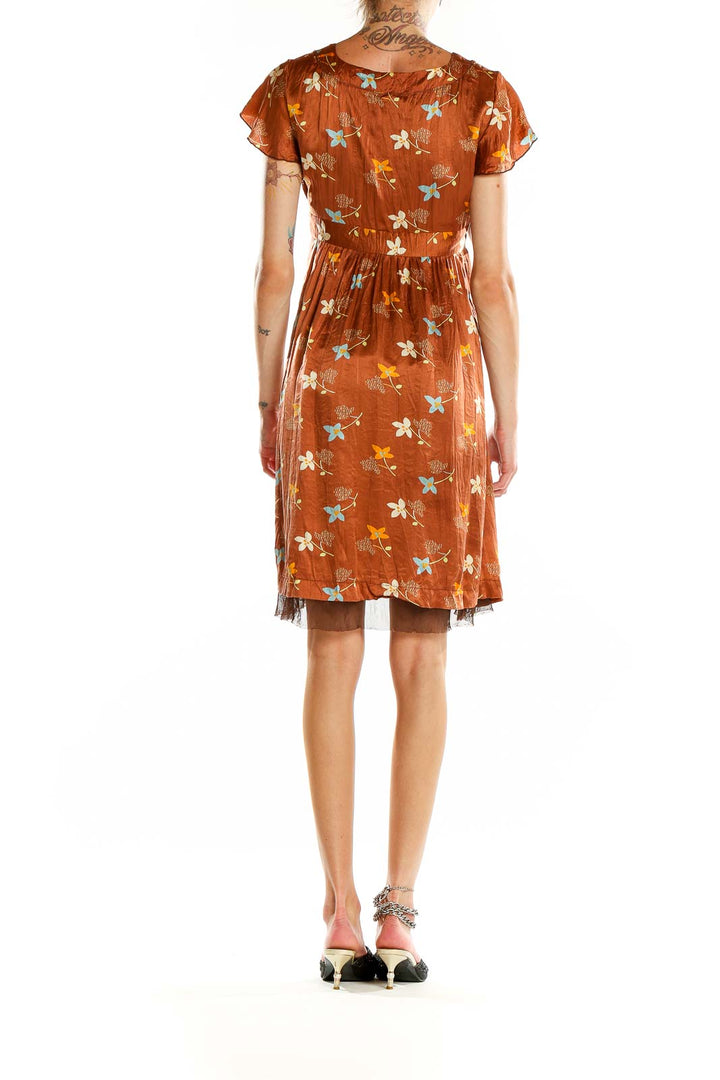 Back view of Free People rust floral empire waist mini dress showing flowy silhouette