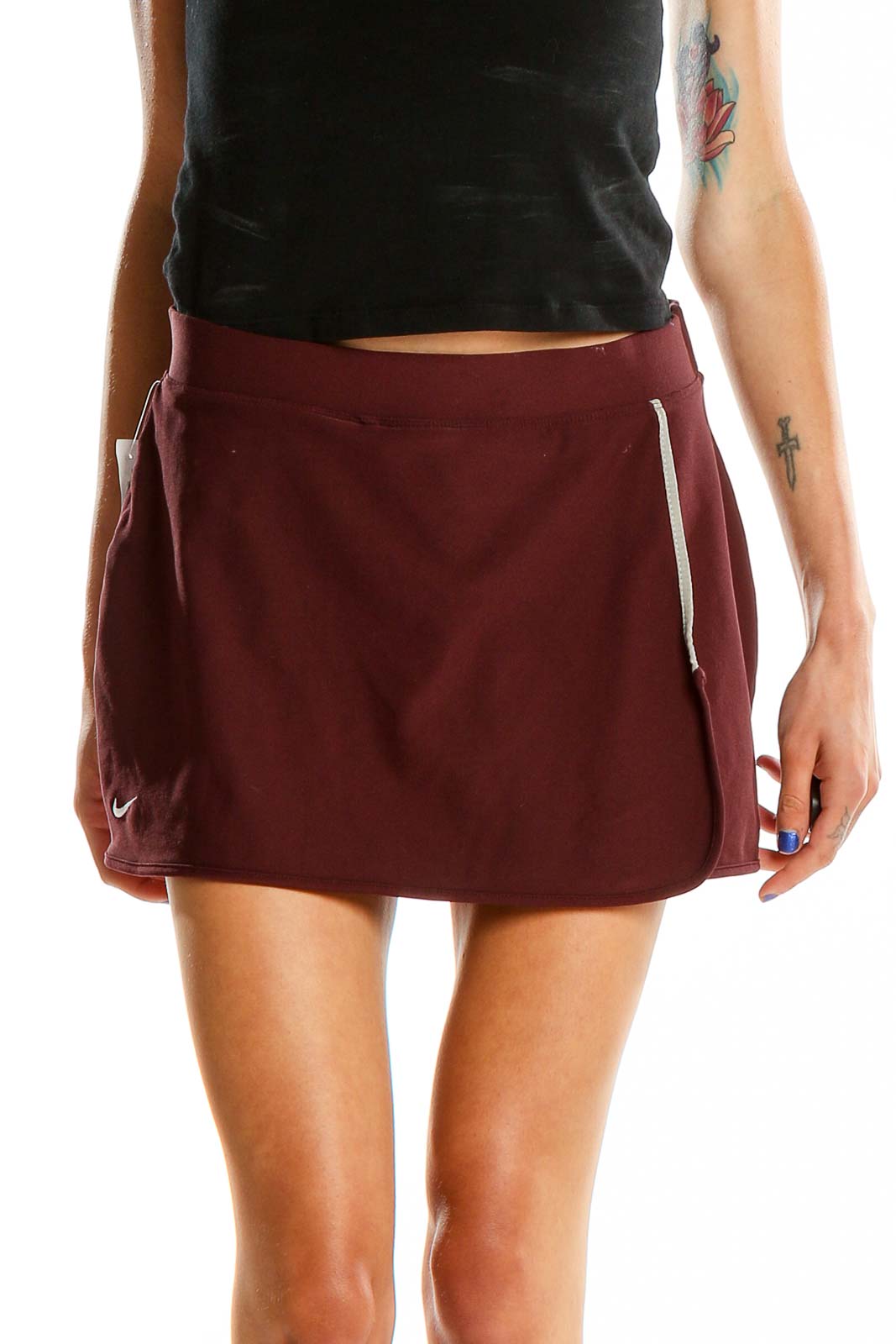 Back view of burgundy Nike athletic skort showing flattering fit