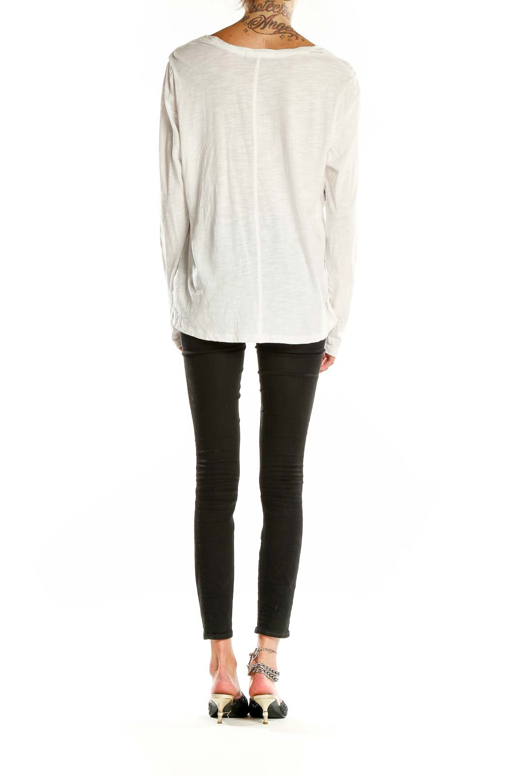 Back view of white long sleeve top showing relaxed fit and length