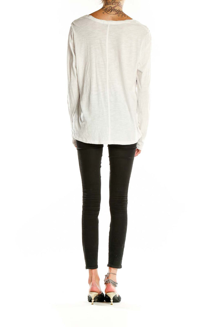 Back view of white long sleeve top showing relaxed fit and length