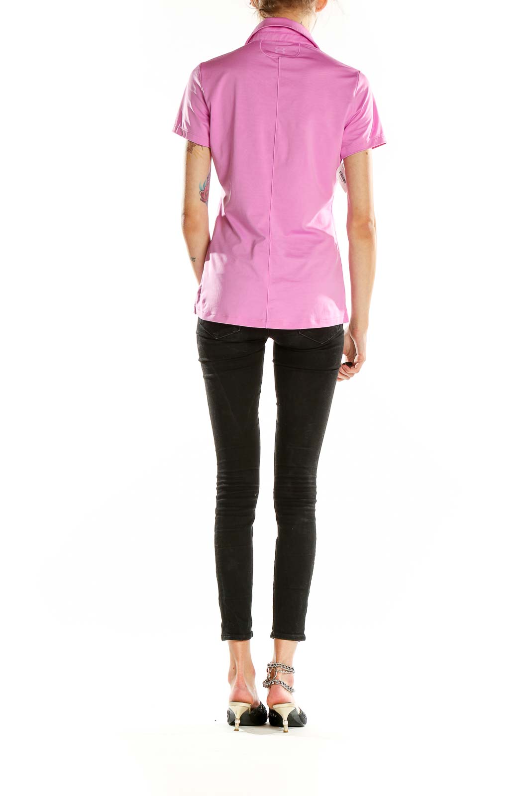 Back view of pink Under Armour performance polo shirt on model