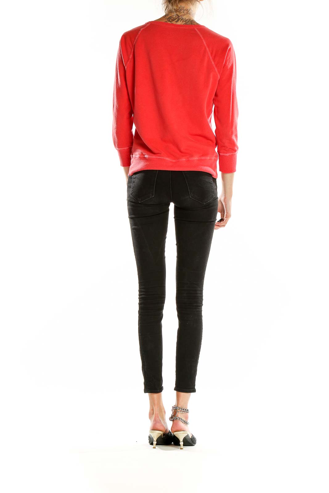 Back view of red J.Crew cotton crewneck sweatshirt on model with black jeans