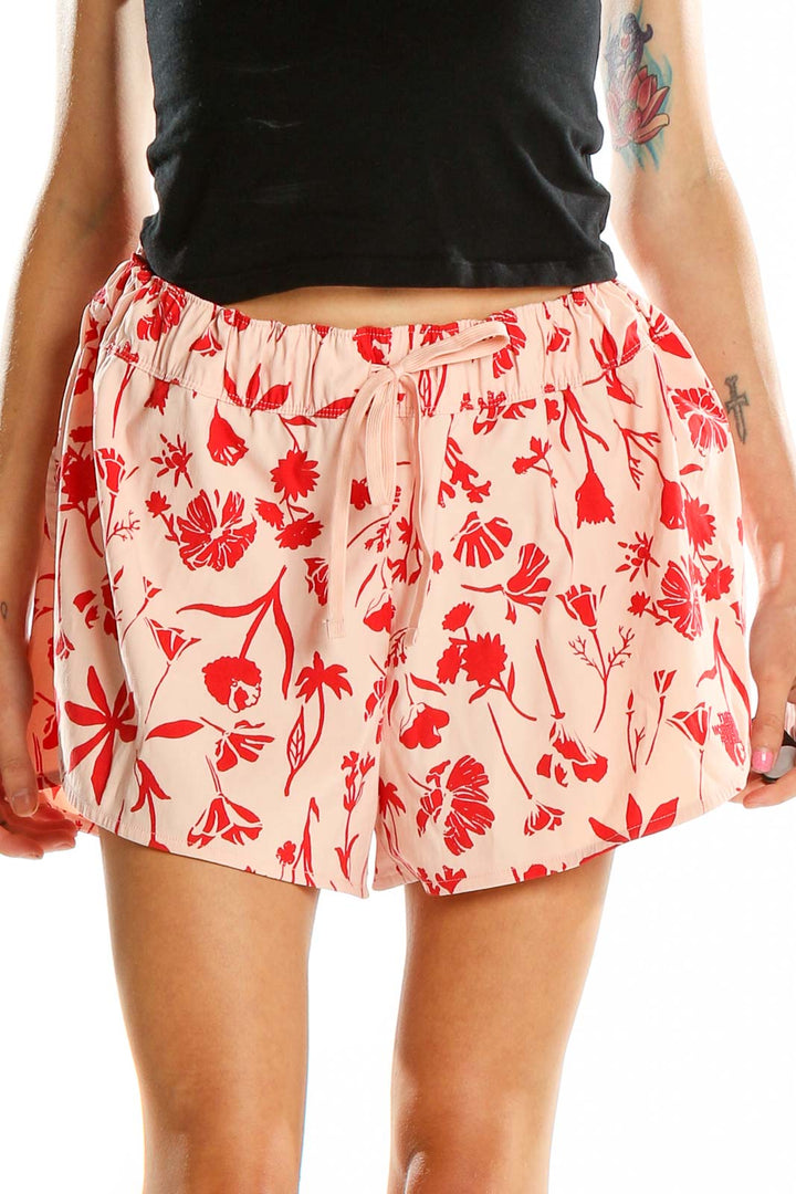 Front view of pink floral print shorts from The North Face with drawstring waist