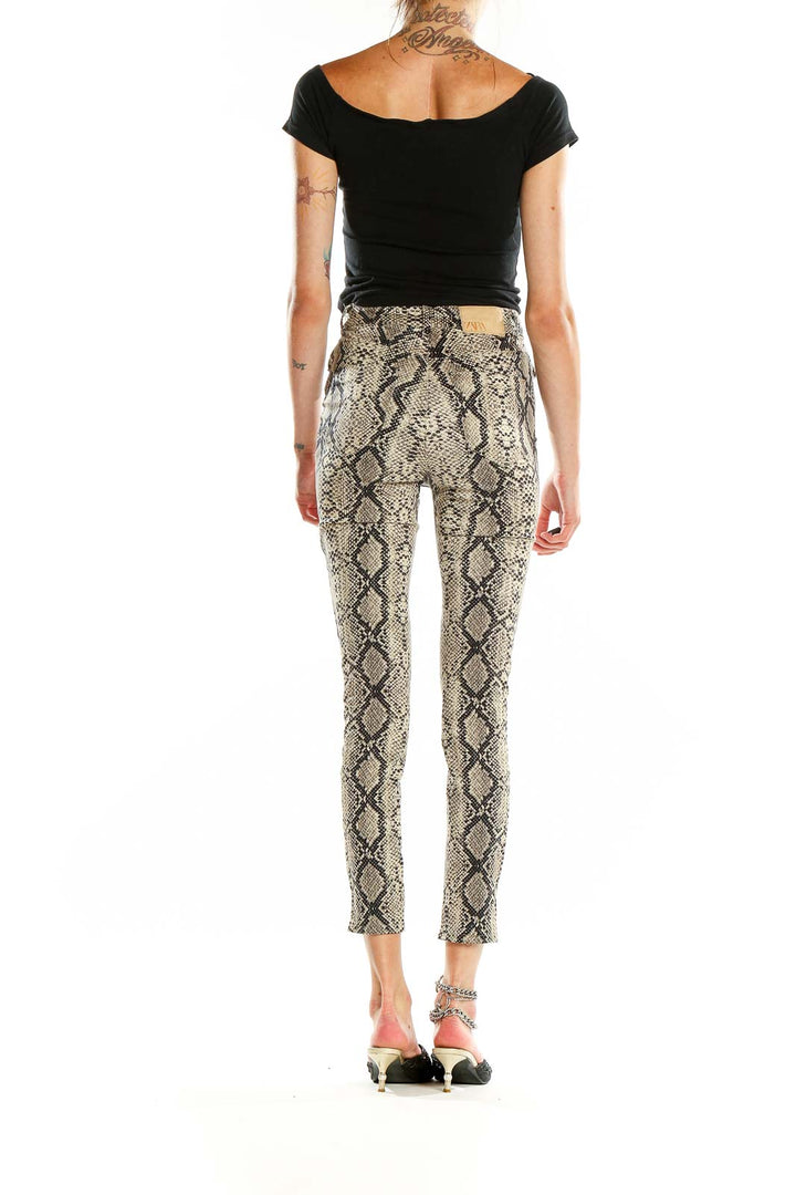 Back view of Zara beige snake print skinny pants on model