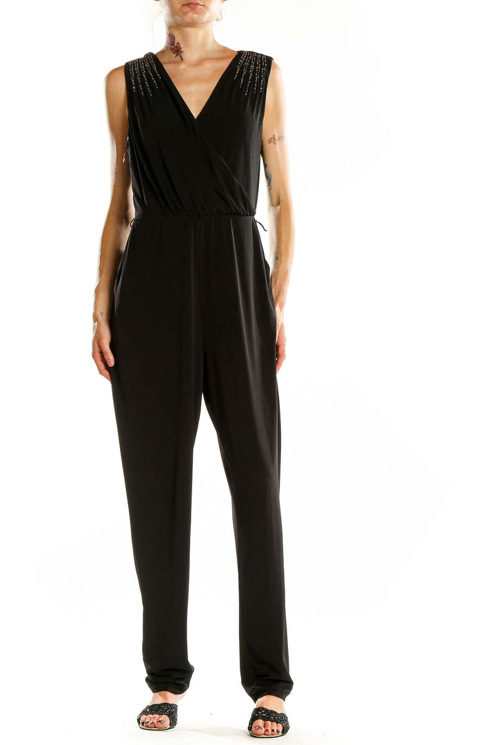 Front view of Calvin Klein black jumpsuit with V-neck and embellished shoulders