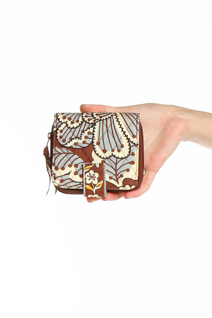 Front view of Vera Bradley Brown Floral Print Clutch held in hand