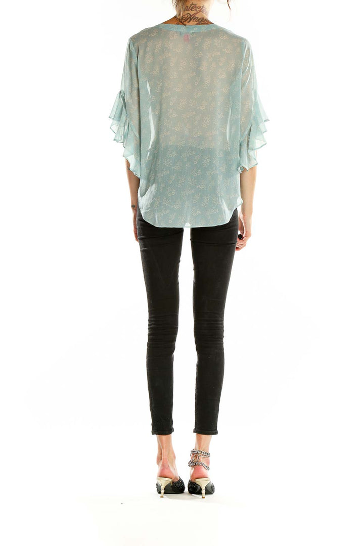 Back view of Vince Camuto mint floral sheer blouse showing full length and pattern