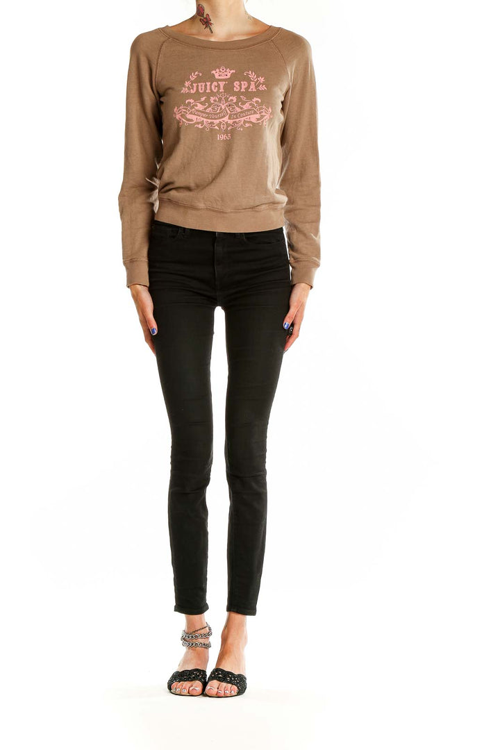 Front view of tan Juicy Couture sweatshirt with pink logo graphic