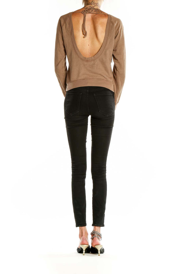 Back view of tan Juicy Couture sweatshirt showing open scoop design