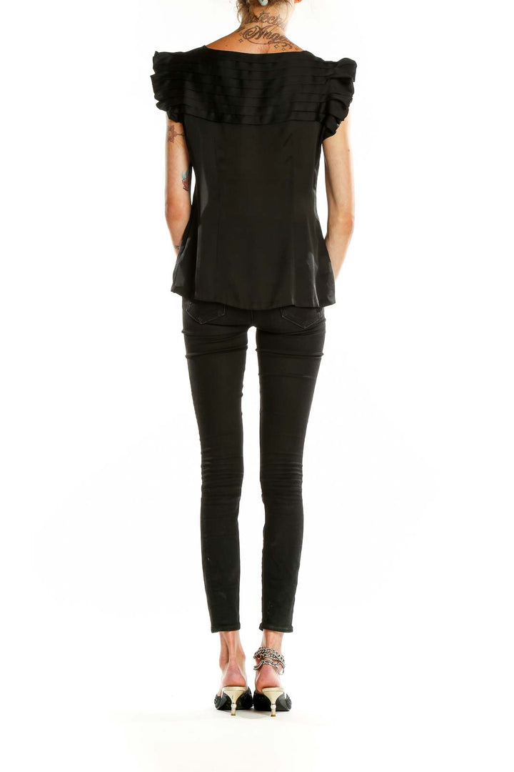 Back view of BCBG MaxAzria black sleeveless blouse showing smooth silhouette