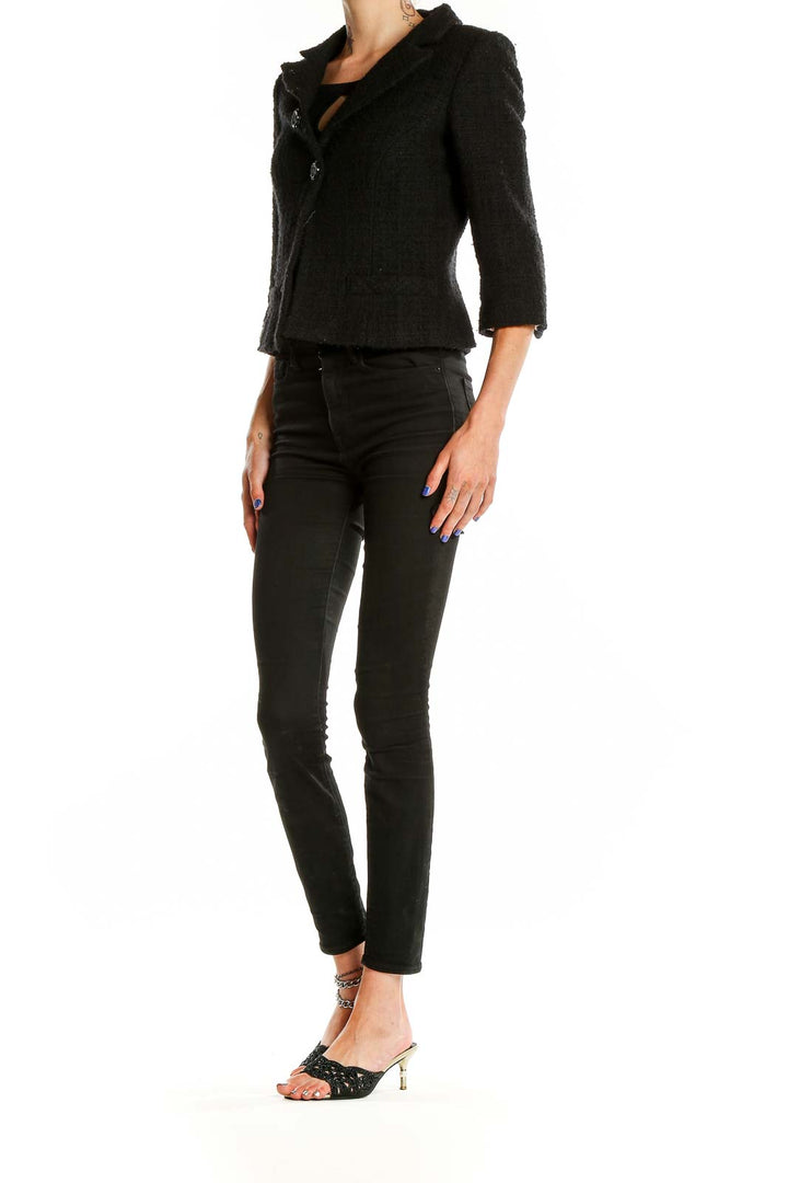 Front view of Milly black textured cropped blazer with three-button closure