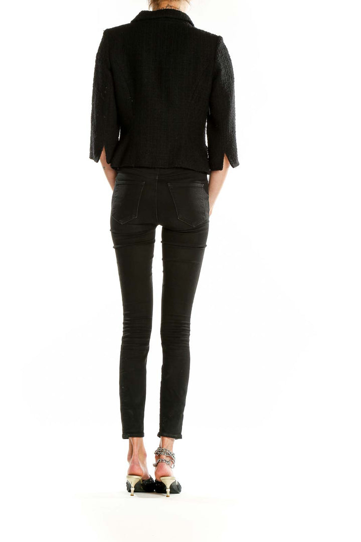 Back view of Milly black textured cropped blazer showing tailored fit