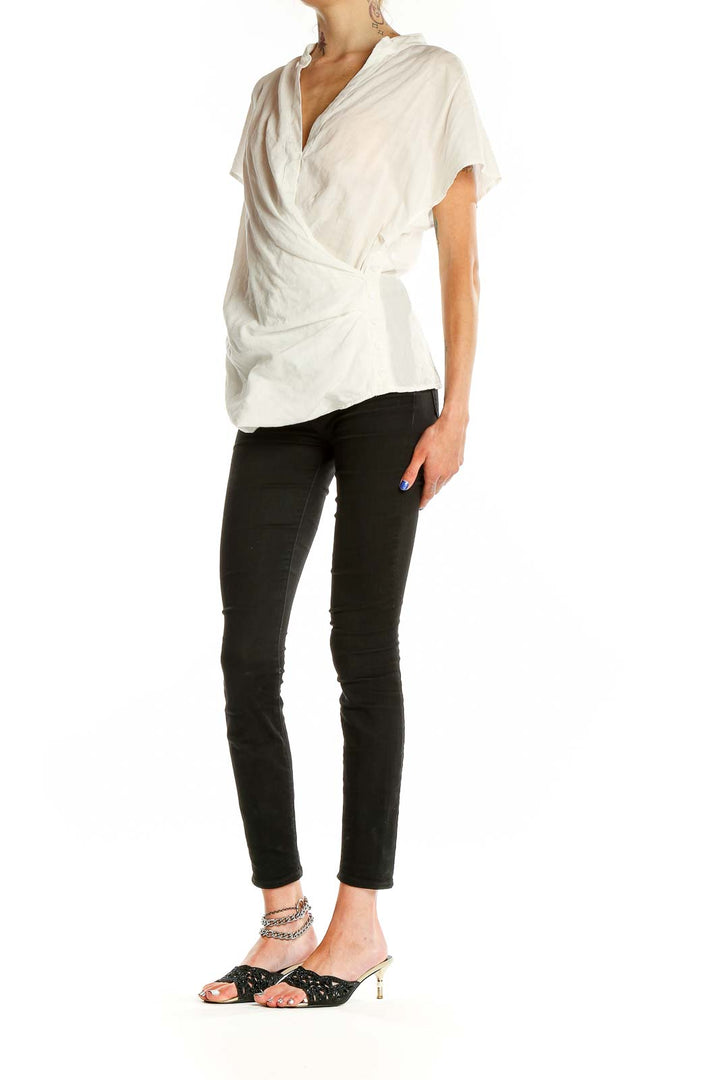 Front view of Akemi + Kin white wrap-style short sleeve blouse