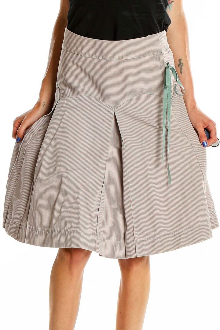 Front view of MARC JACOBS beige pleated A-line midi skirt with pinstripe pattern and mint ribbon detail