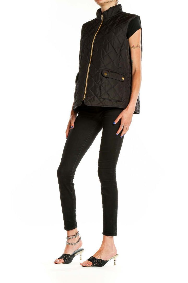 Front view of St. John's Bay black quilted vest with gold-tone zipper