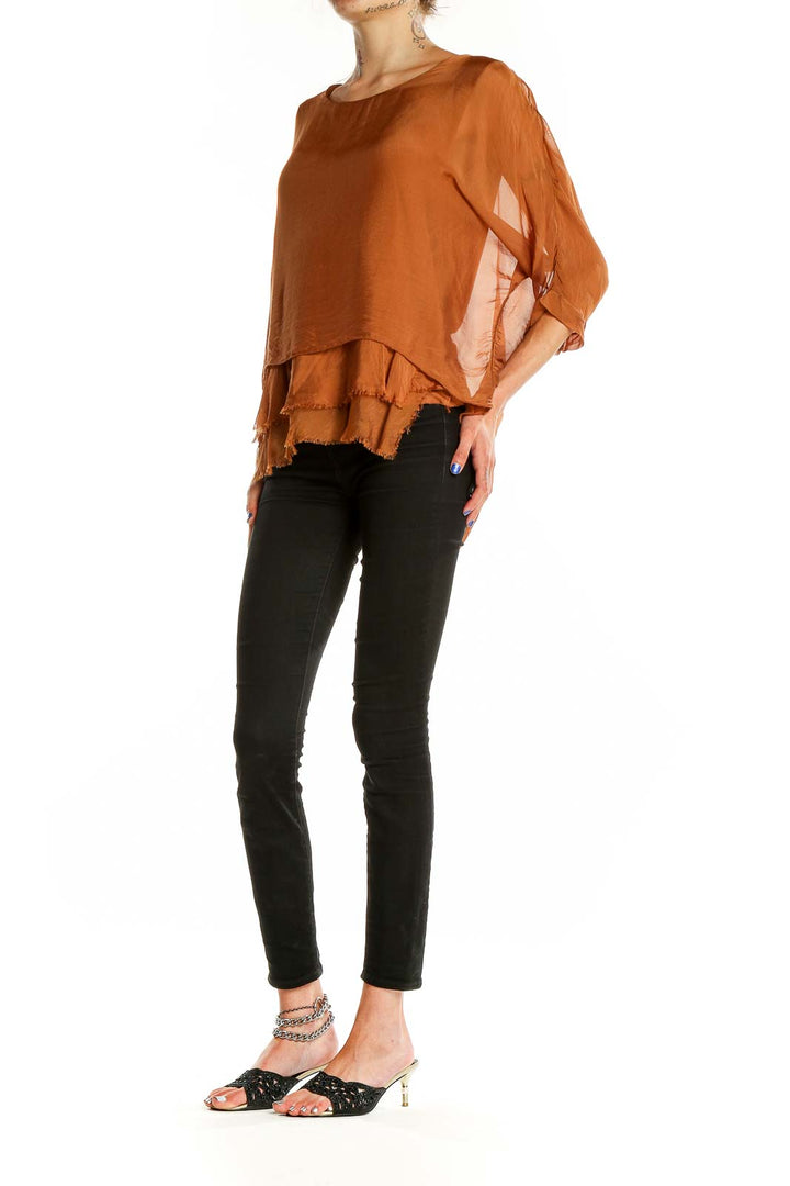 Front view of Gigi moda rust flowy layered blouse with billowing sleeves