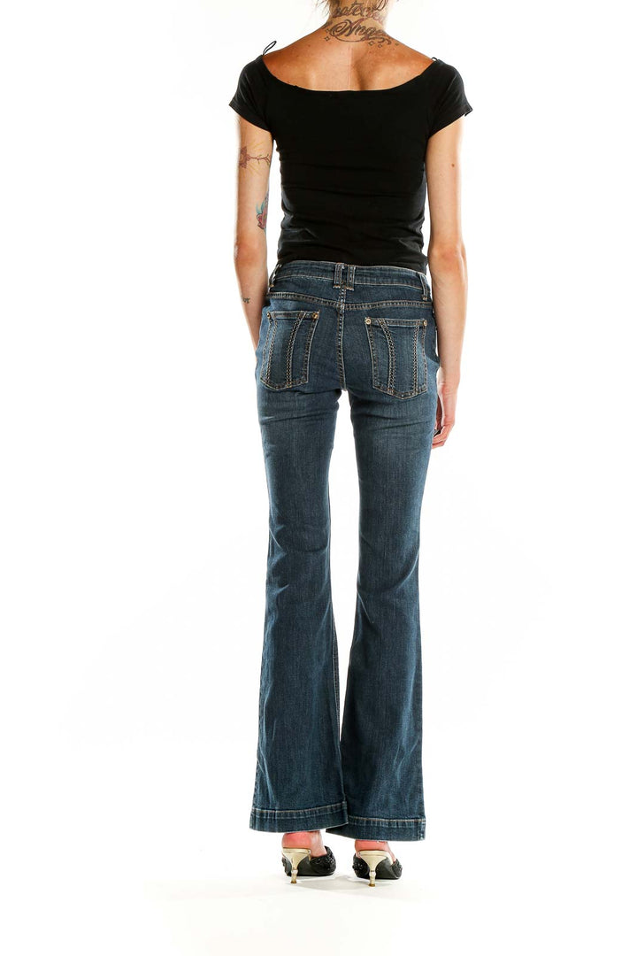 Back view of Cache blue flared denim jeans on model