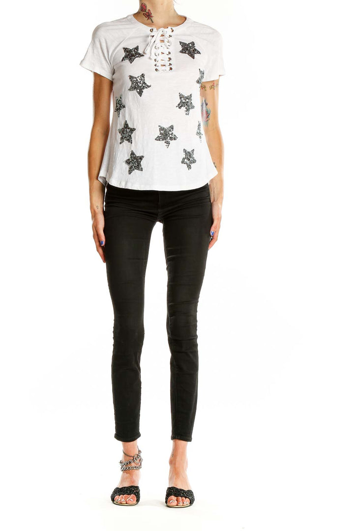 Front view of white INC t-shirt with sequin stars and lace-up neckline