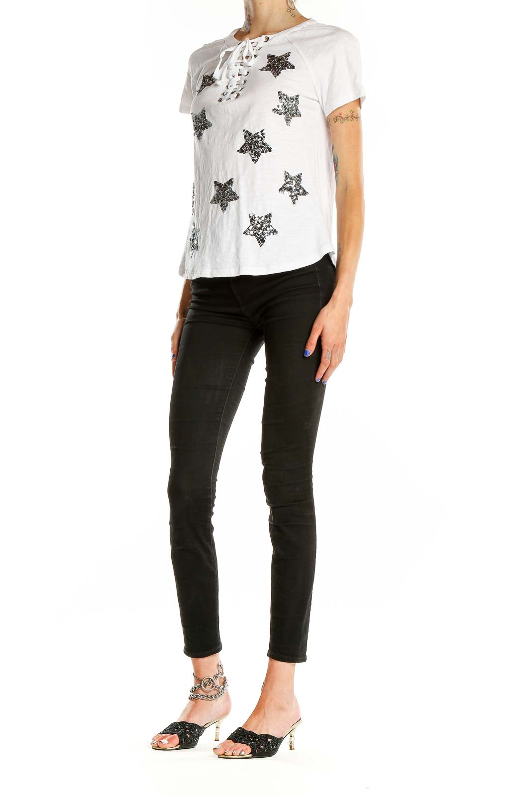 Front view of white INC t-shirt with sequin stars and lace-up neckline