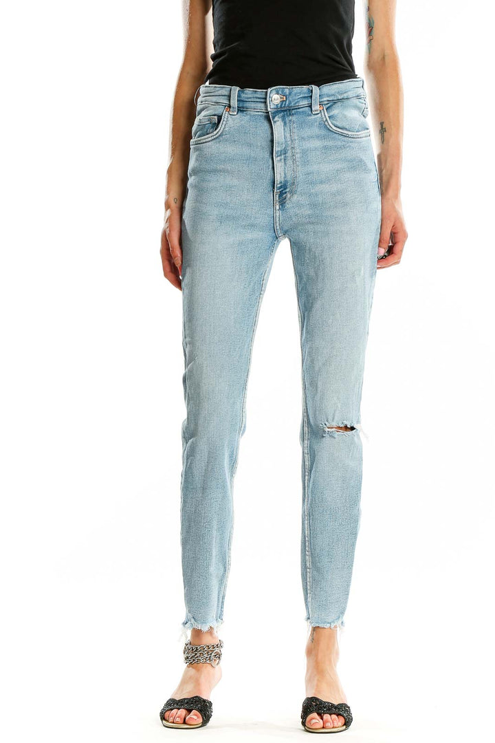 Front view of Zara light blue high-waisted skinny jeans with distressed knee