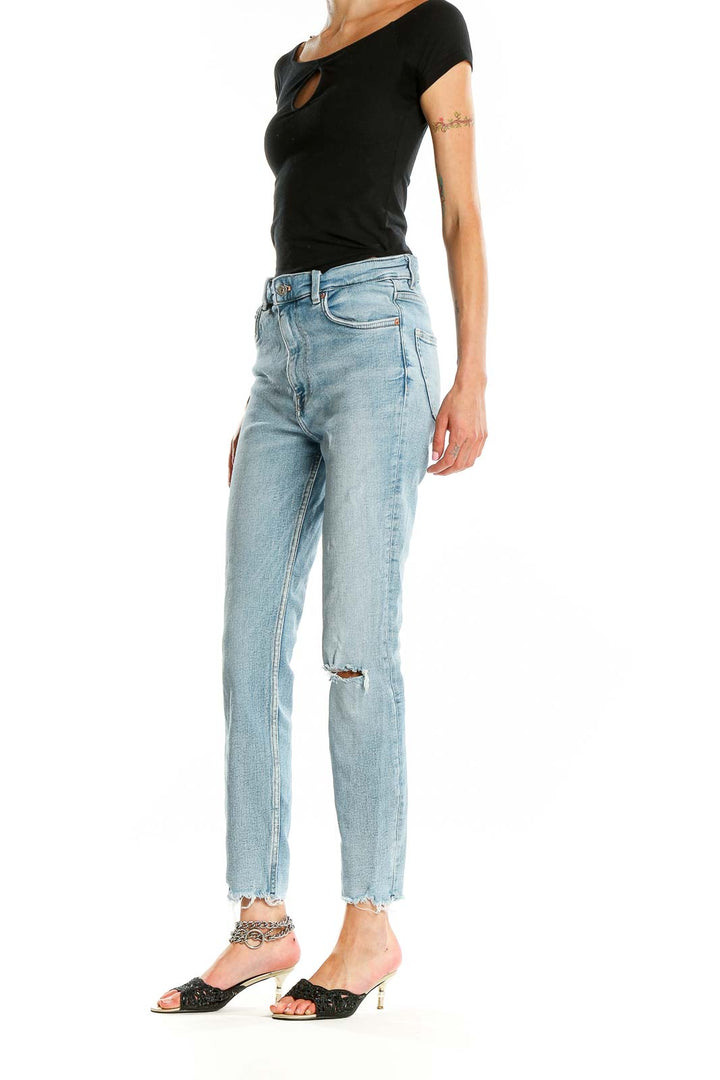 Front view of Zara light blue high-waisted skinny jeans with distressed knee