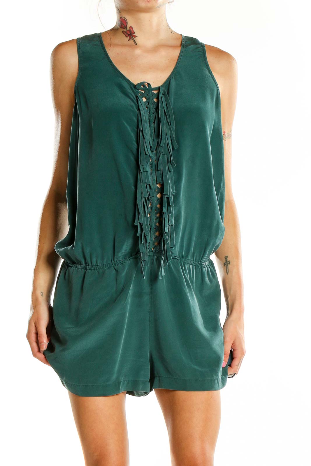 Front view of Boden green silk romper with lace-up front and fringe details