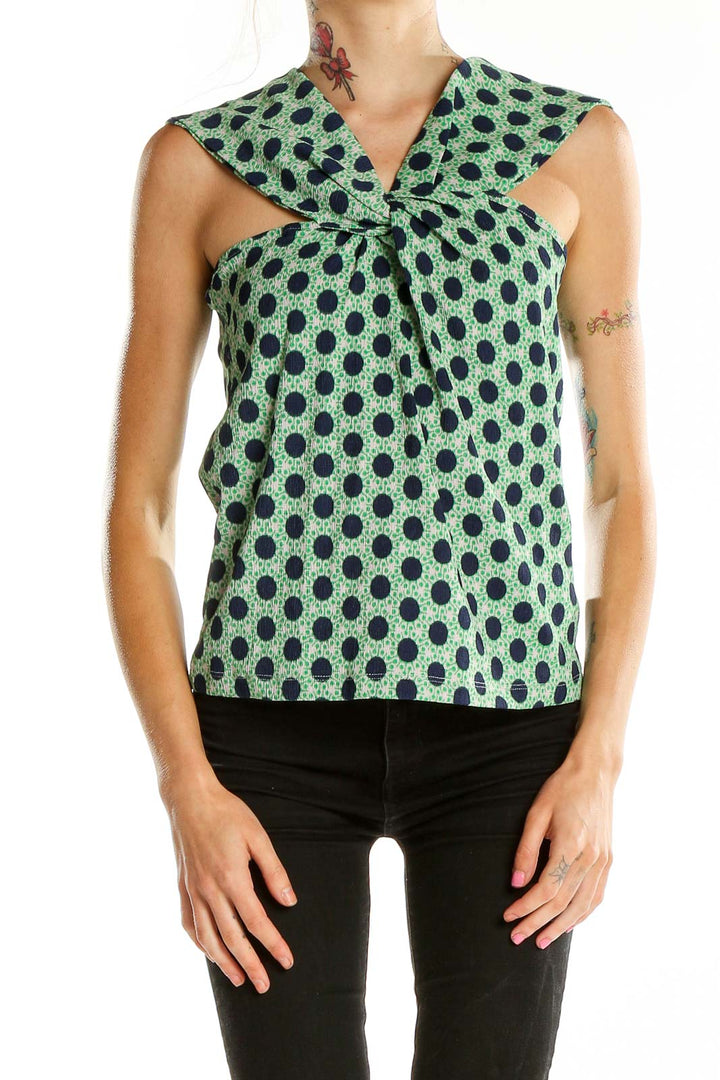 Front view of Maeve green polka dot sleeveless top with twist-front design