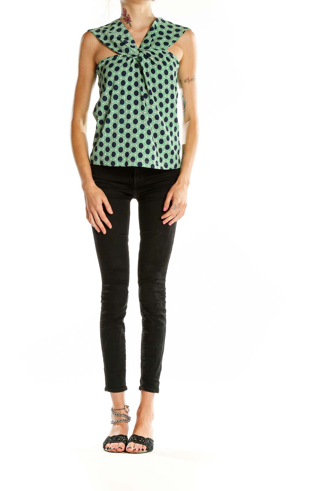 Front view of Maeve green polka dot sleeveless top with twist-front design