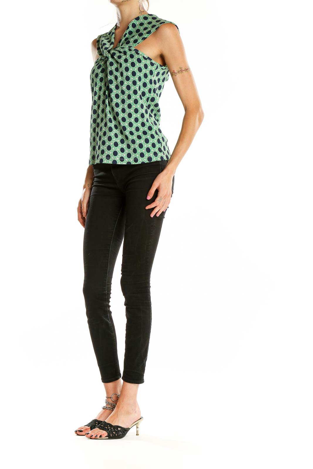 Front view of Maeve green polka dot sleeveless top with twist-front design