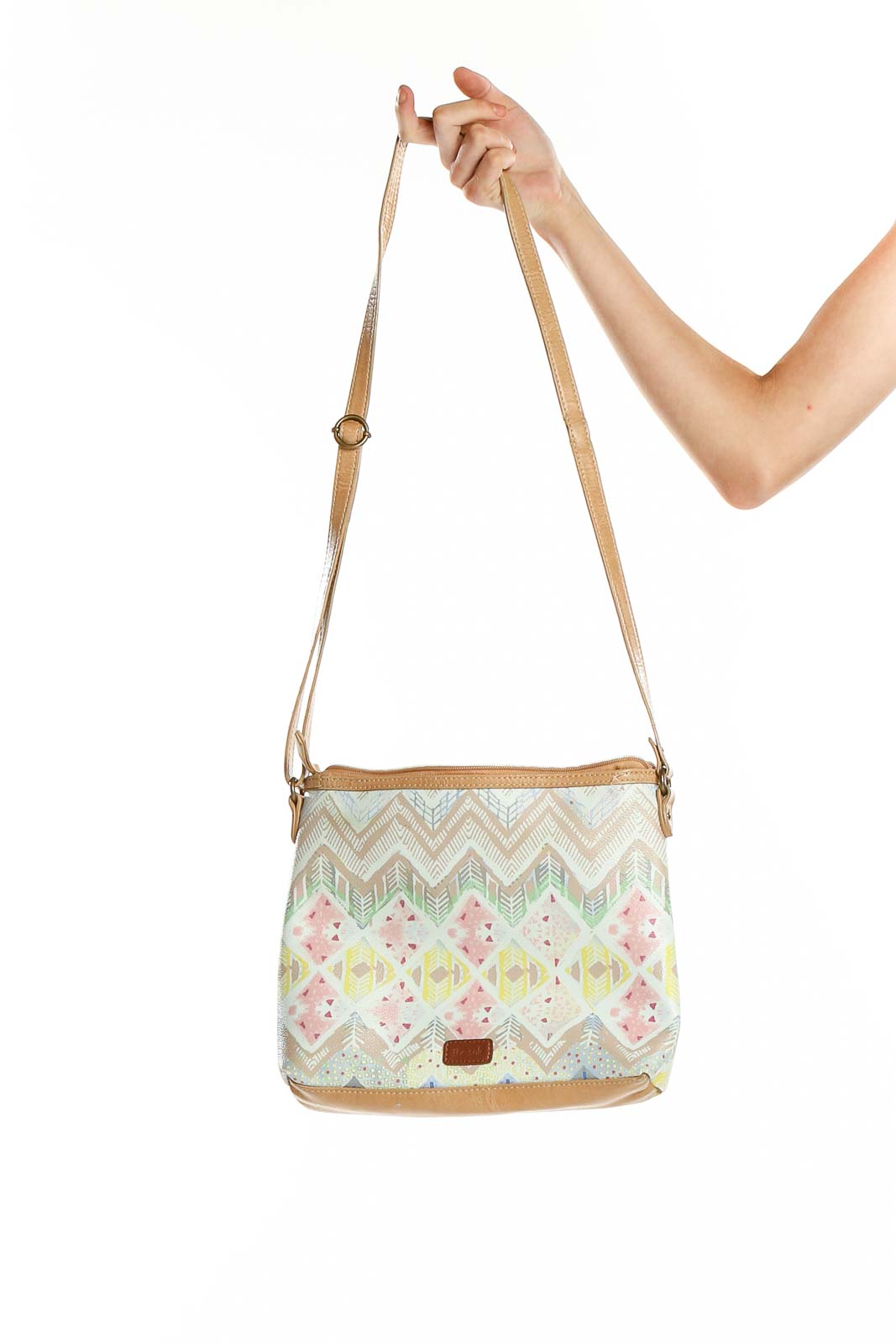 Front view of The SAK beige patterned crossbody shoulder bag with chevron and floral design