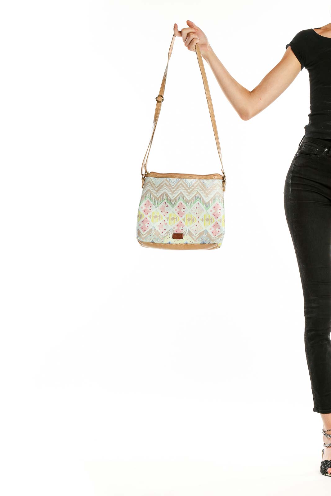 Front view of The SAK beige patterned crossbody shoulder bag with chevron and floral design