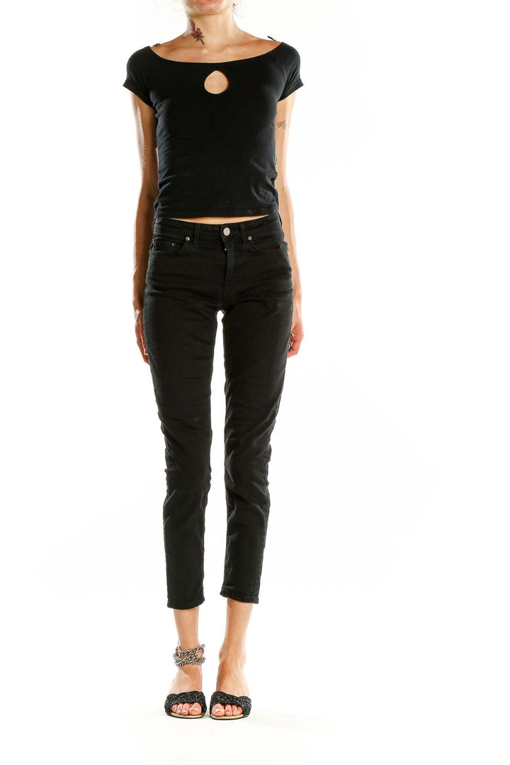 Front view of Acne black slim-fit cropped jeans on model