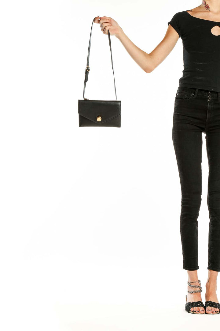 Front view of black Zara envelope crossbody bag with gold-tone button