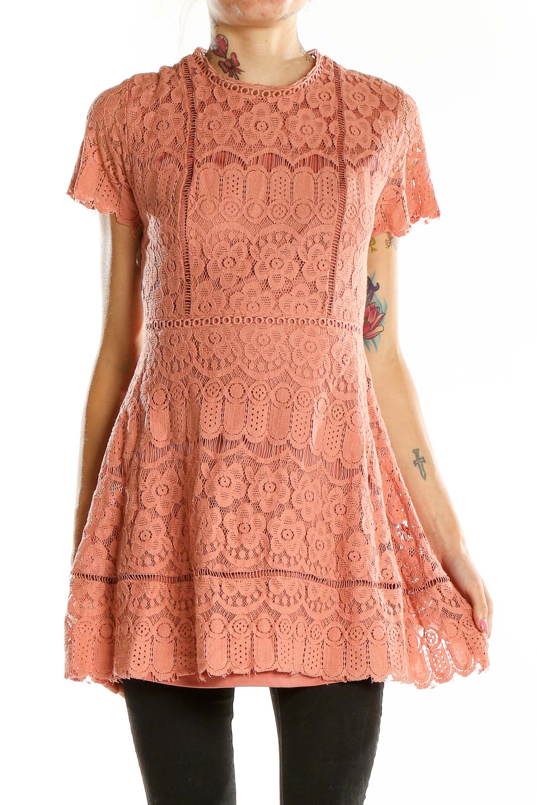 Front view of coral lace mini dress with short sleeves and tiered design