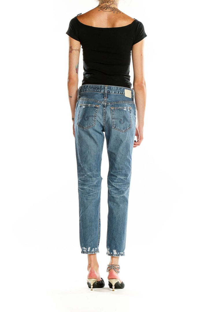 Back view of Adriano Goldschmied blue distressed boyfriend jeans showing pocket design